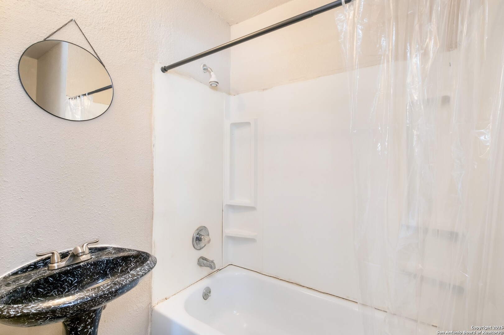 5207 Overpool Street San Antonio, TX 78228 - Photo 16 of 31 a bathroom with a sink and a mirror