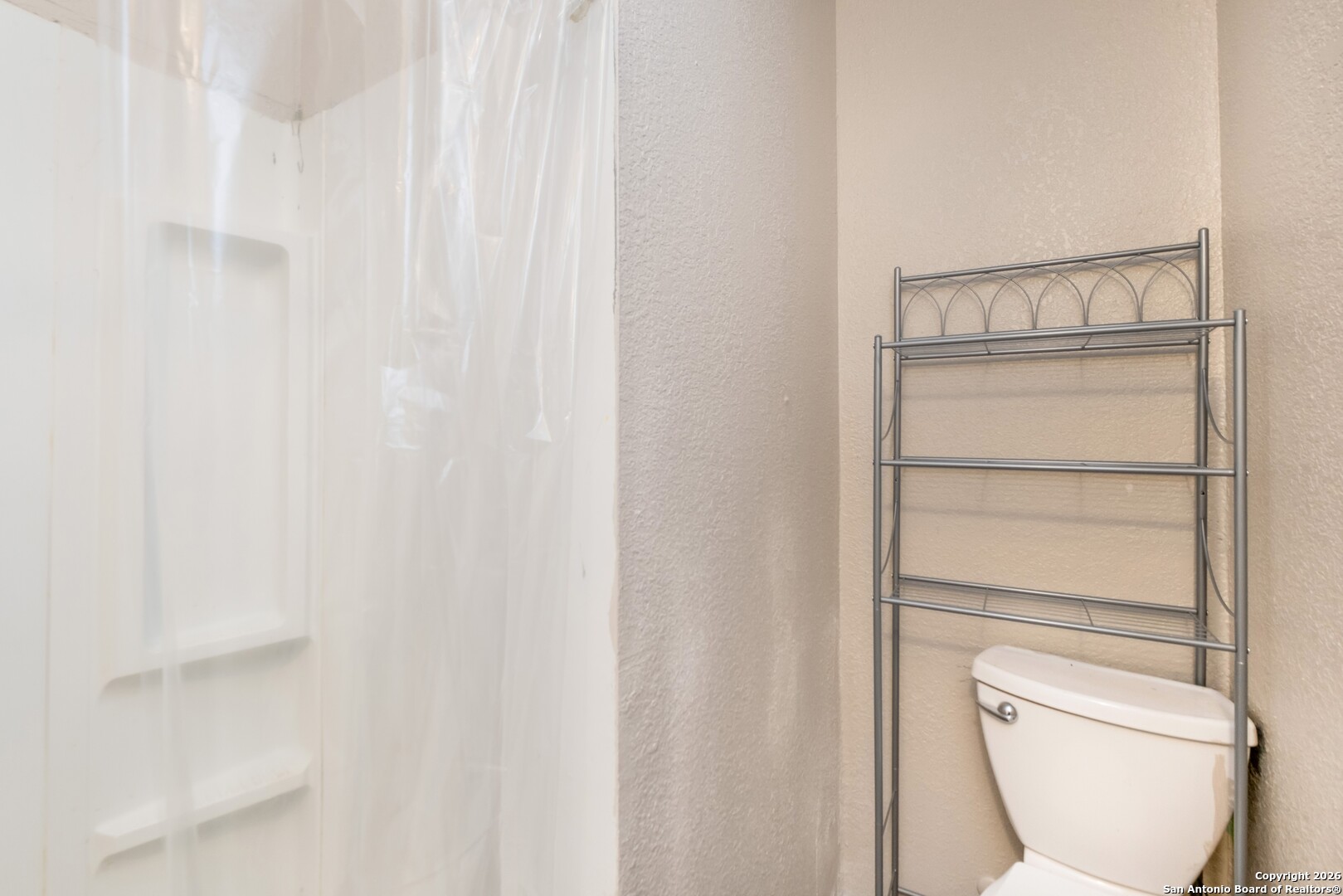5207 Overpool Street San Antonio, TX 78228 - Photo 17 of 31 a bathroom with a toilet a sink and a window
