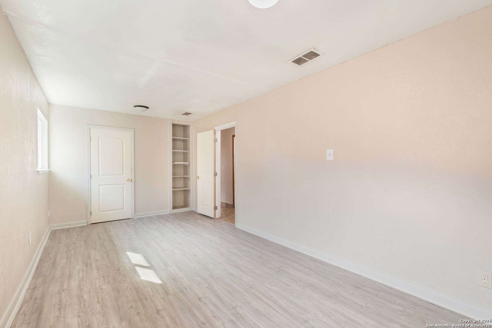 5207 Overpool Street San Antonio, TX 78228 - Photo 19 of 31 a view of an empty room with wooden floor
