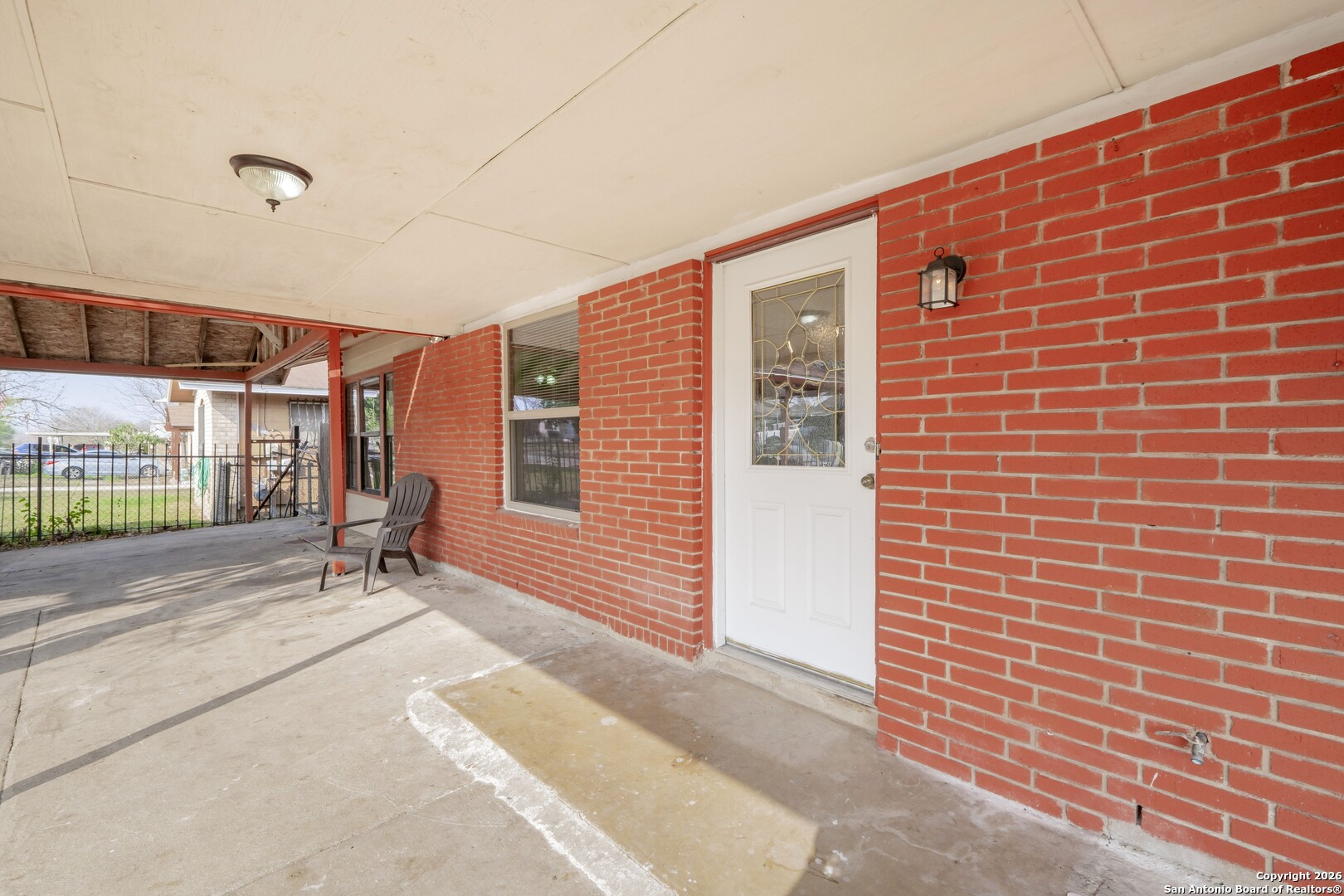 5207 Overpool Street San Antonio, TX 78228 - Photo 4 of 31 a backyard with brick wall and brick wall