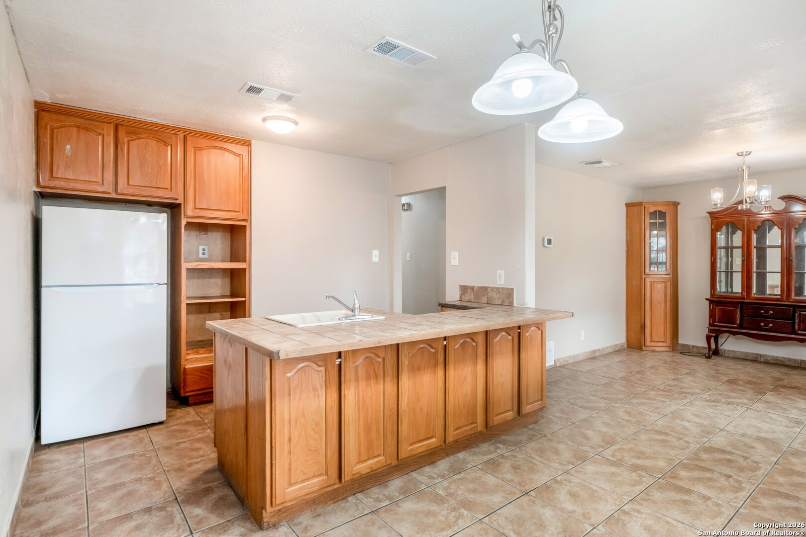 5207 Overpool Street San Antonio, TX 78228 - Photo 7 of 31 a kitchen with stainless steel appliances granite countertop a refrigerator a sink dishwasher a oven and a dining table with the view of kitchen