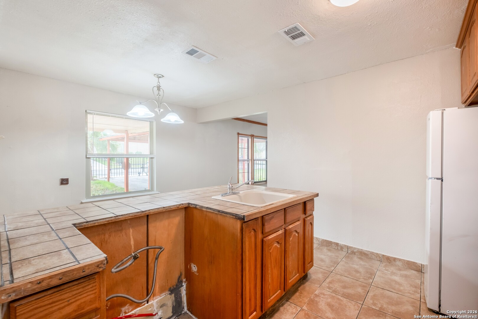 5207 Overpool Street San Antonio, TX 78228 - Photo 9 of 31 a kitchen with a stove a sink and a window