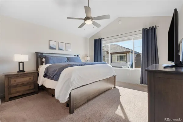 a bed room with a bed window and a flat screen tv
