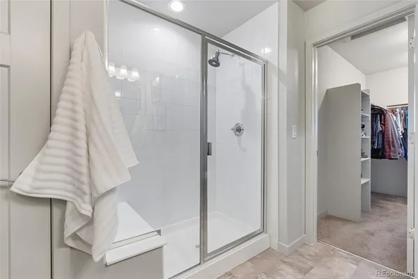 a bathroom with a shower and a mirror