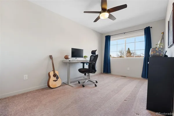 a view of a workspace with furniture and a window