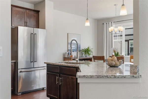 a kitchen with a refrigerator and a sink