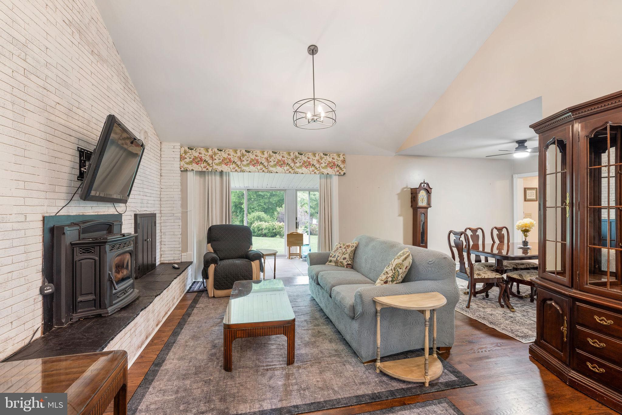 6605 Mt Vista Road Kingsville, MD 21087 - Photo 10 of 54 a living room with furniture a fireplace and a flat screen tv