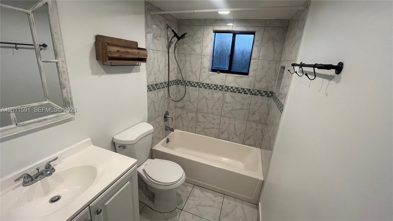 8540 Southwest 133rd Avenue Road, Unit 316 Miami, FL 33183 - Photo 17 of 18 a bathroom with a sink a toilet a mirror and shower