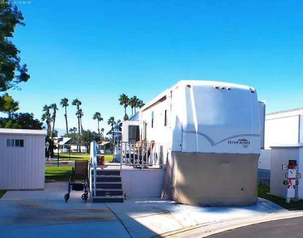 a view of a patio with table and chairs potted plants and wooden floor