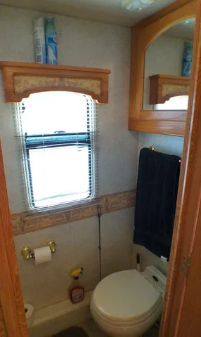 a view of spacious bathroom with sinks and mirror