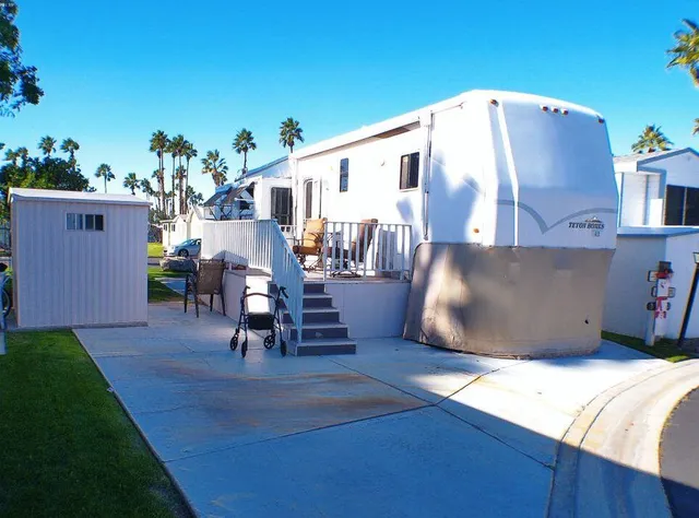 a view of a porch with a table and chairs