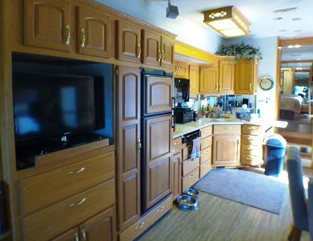 a kitchen with wooden cabinets and a stove top oven