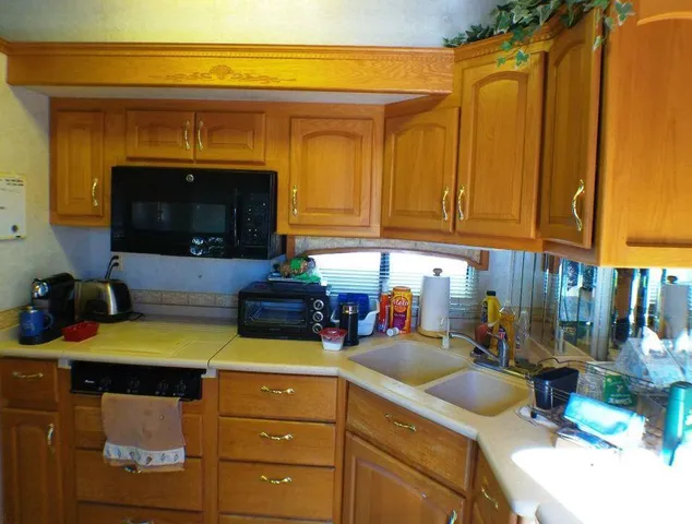 a kitchen with stainless steel appliances granite countertop a stove and a microwave