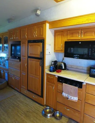 a kitchen with stainless steel appliances granite countertop a sink and a cabinets