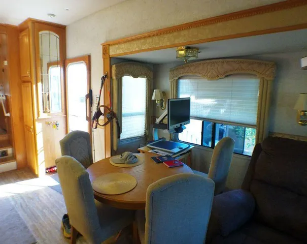 a view of a dining room with furniture and a flat screen tv