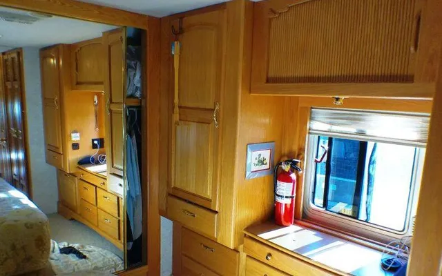 a view of a hallway and a livingroom with furniture