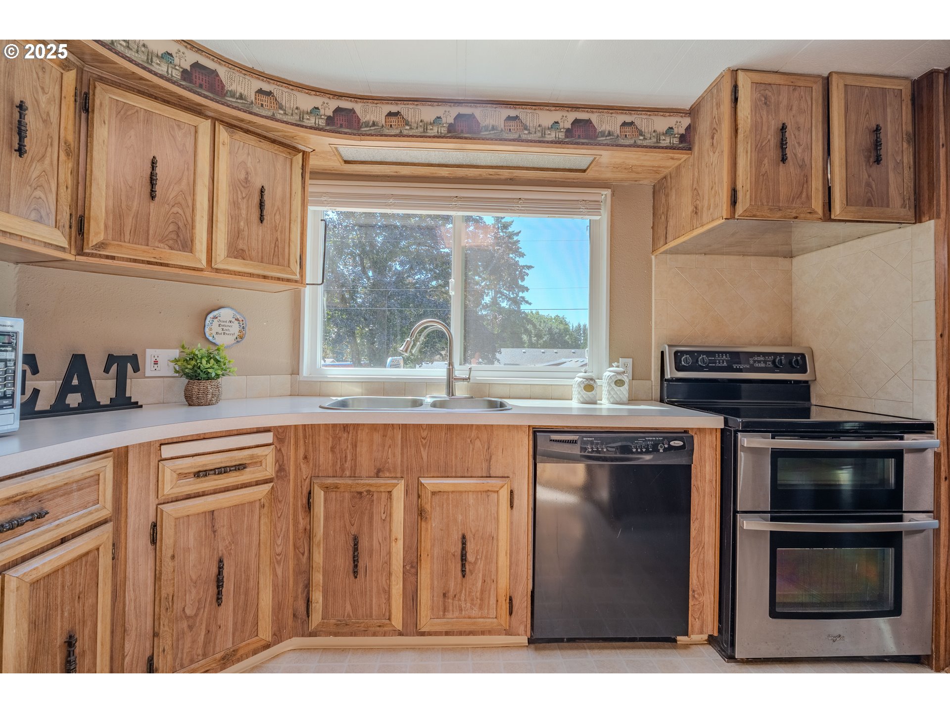 1317 Northeast 267th Avenue Camas, WA 98607 - Photo 16 of 43 a kitchen with stainless steel appliances granite countertop a stove a sink and a microwave