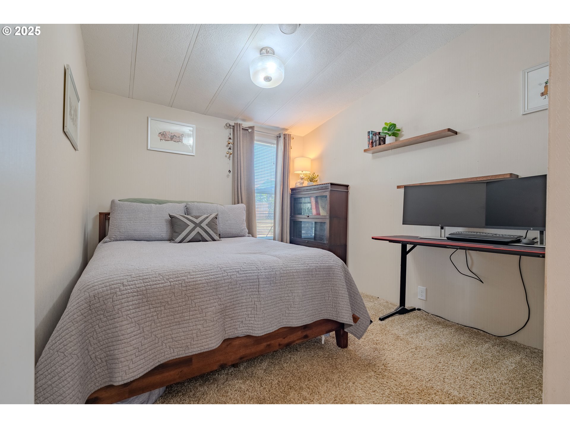 1317 Northeast 267th Avenue Camas, WA 98607 - Photo 18 of 43 a bedroom with a bed and flat screen tv