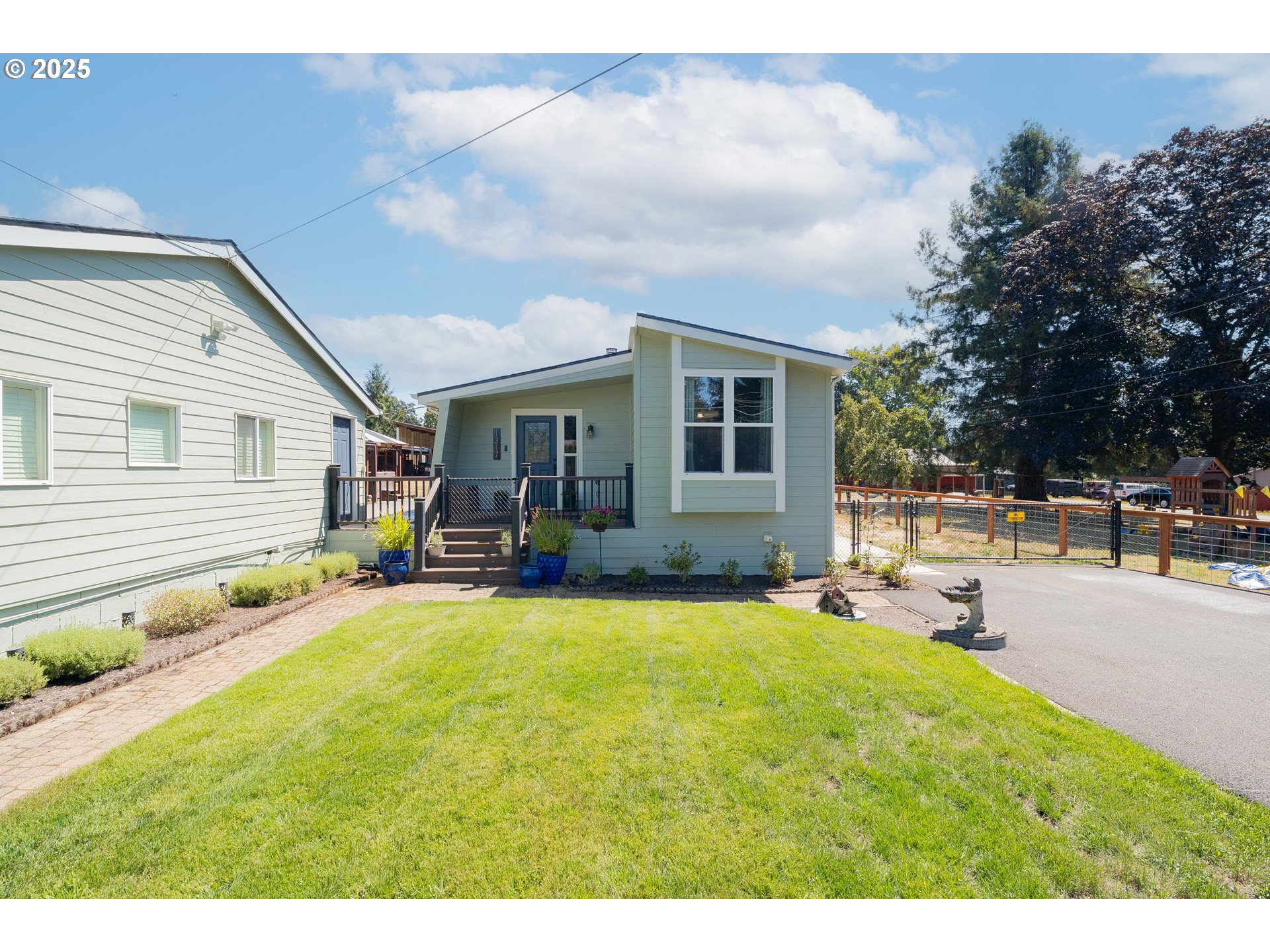 1317 Northeast 267th Avenue Camas, WA 98607 - Photo 2 of 43 a swimming pool with outdoor seating and yard in the back