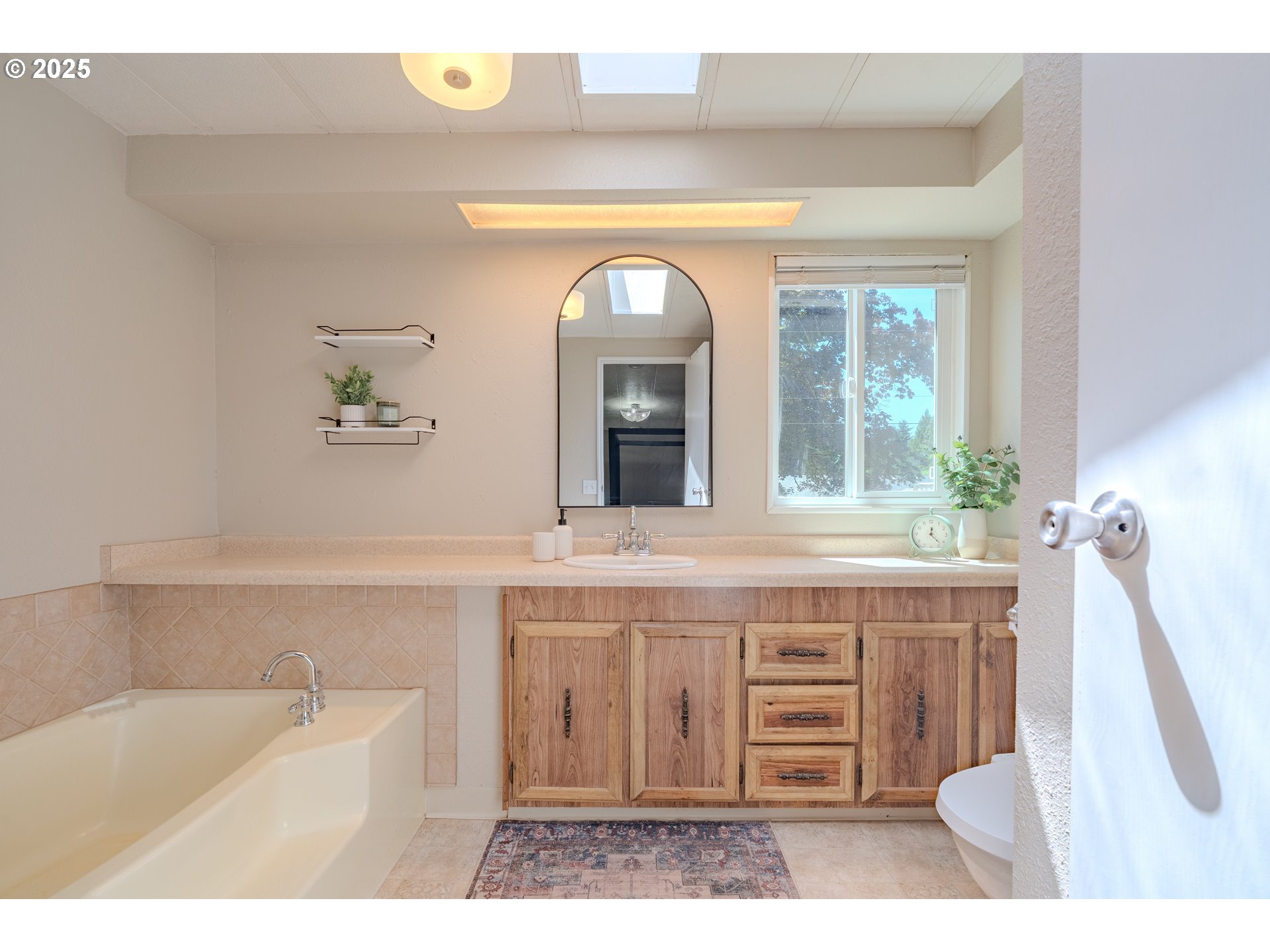 1317 Northeast 267th Avenue Camas, WA 98607 - Photo 28 of 43 a bathroom with a tub a sink and mirror