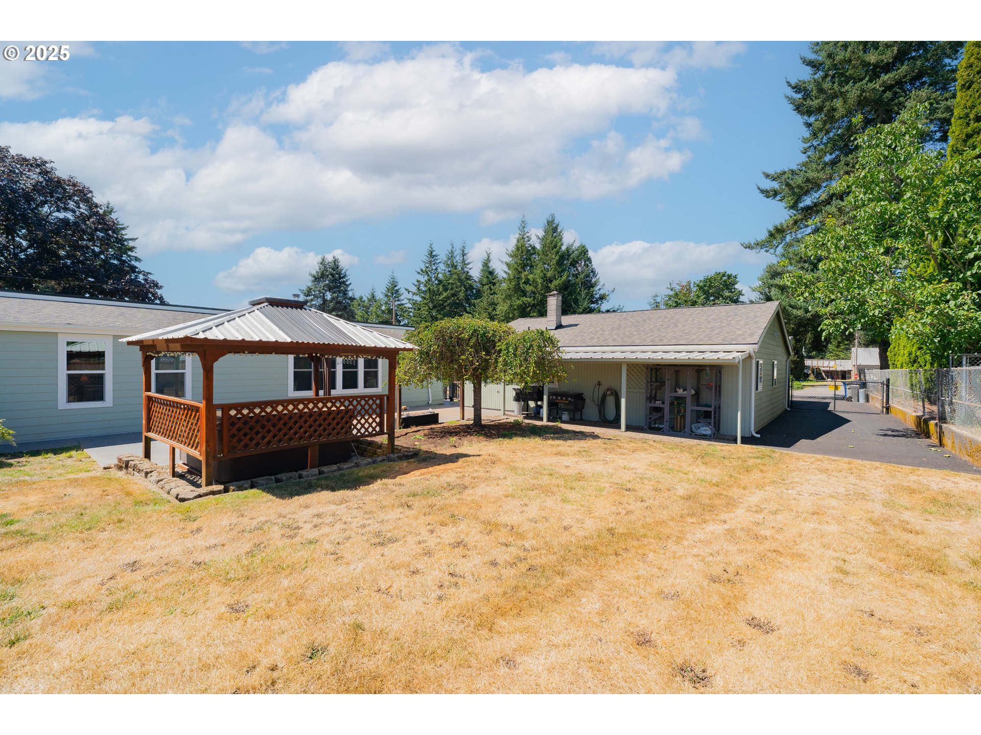 1317 Northeast 267th Avenue Camas, WA 98607 - Photo 34 of 43 a tall yellow house with a large tree in front of it