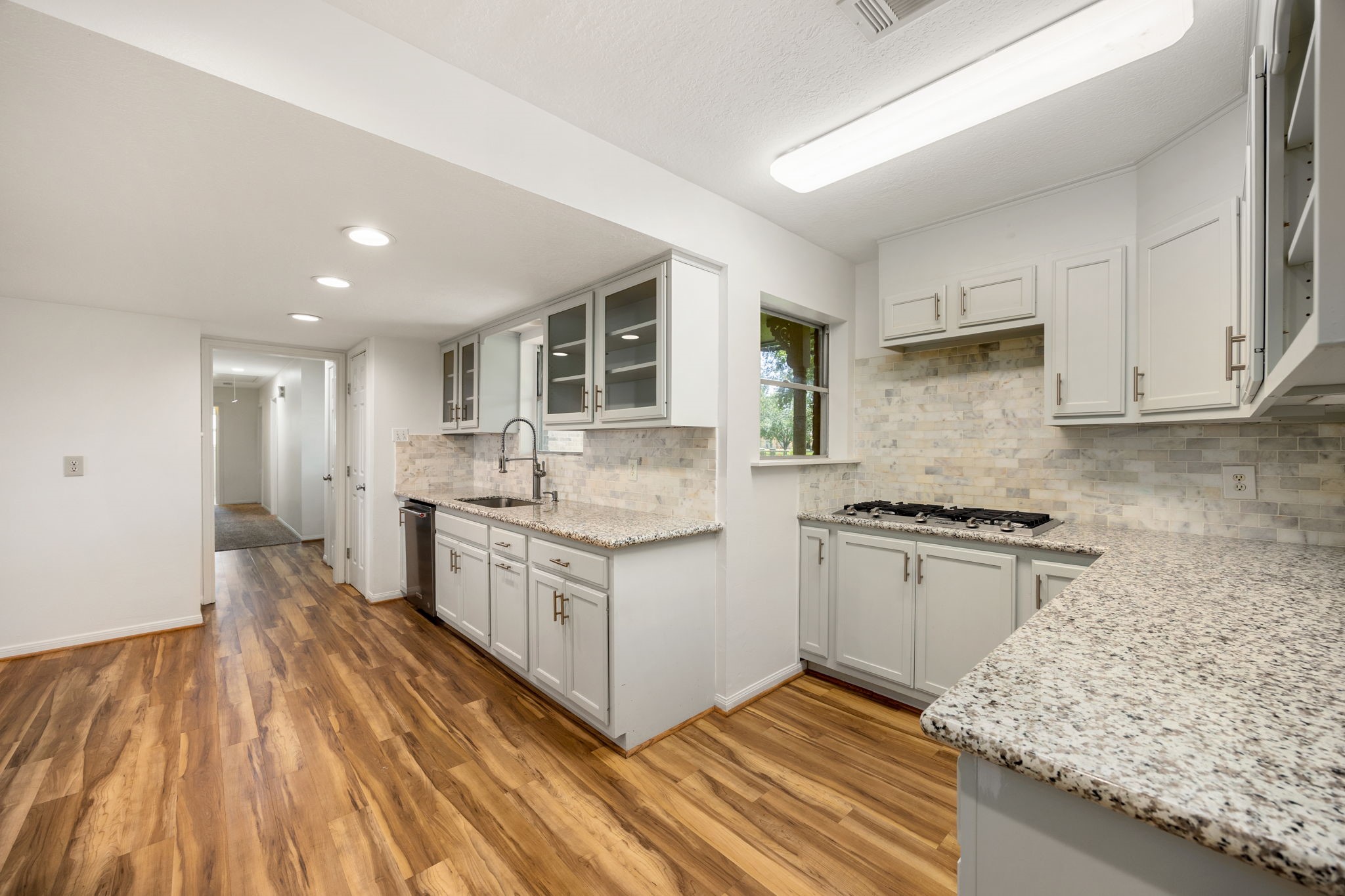 3530 Katy Hockley Road Katy, TX 77493 - Photo 7 of 25 a kitchen with granite countertop a sink stove and cabinets