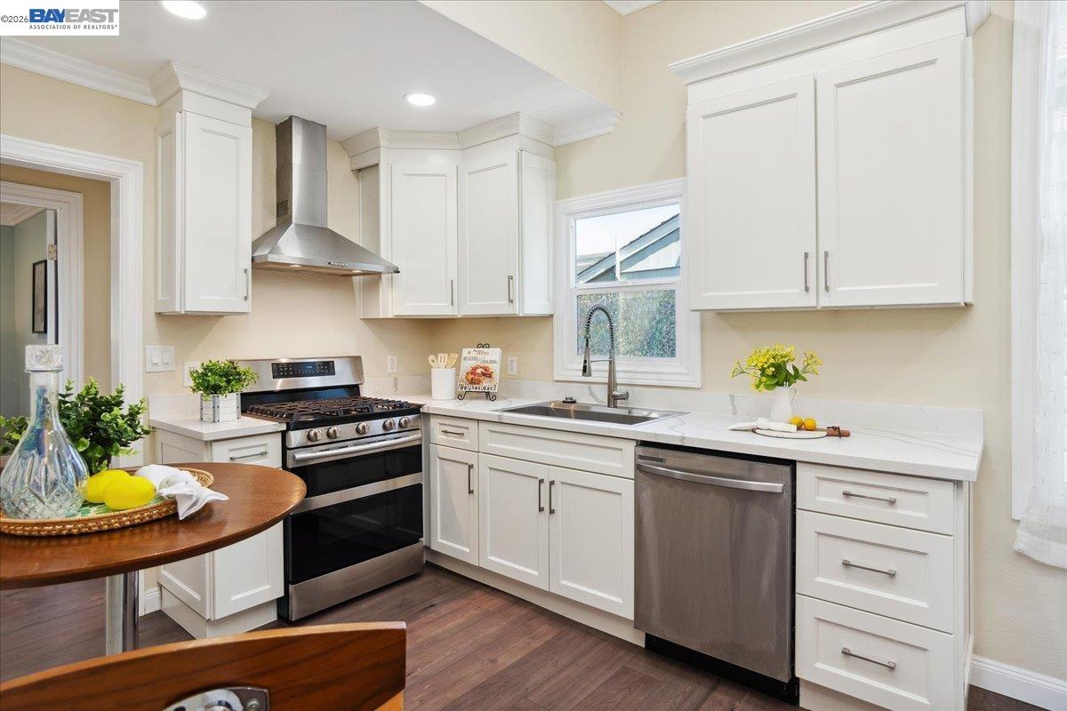 1813 Minturn Street Alameda, CA 94501 - Photo 11 of 29 a kitchen with stainless steel appliances stove a sink and white cabinets