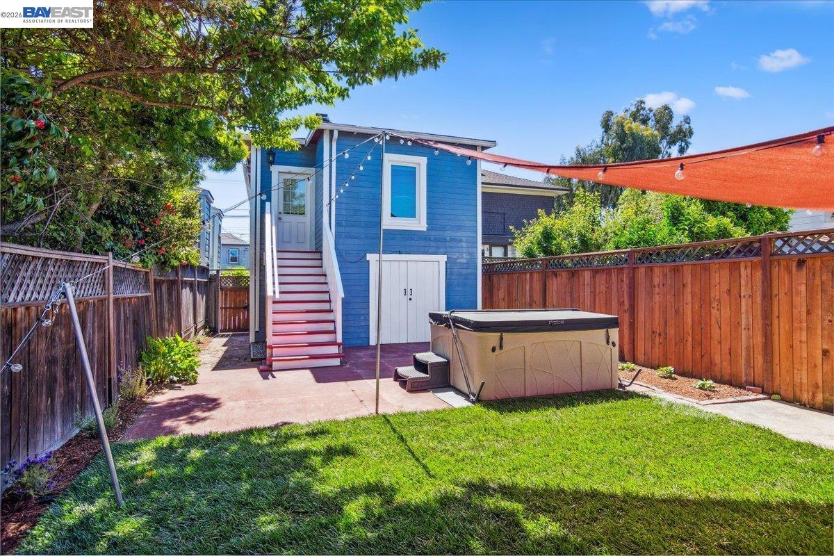 1813 Minturn Street Alameda, CA 94501 - Photo 24 of 29 a view of a backyard with a large tree and wooden fence