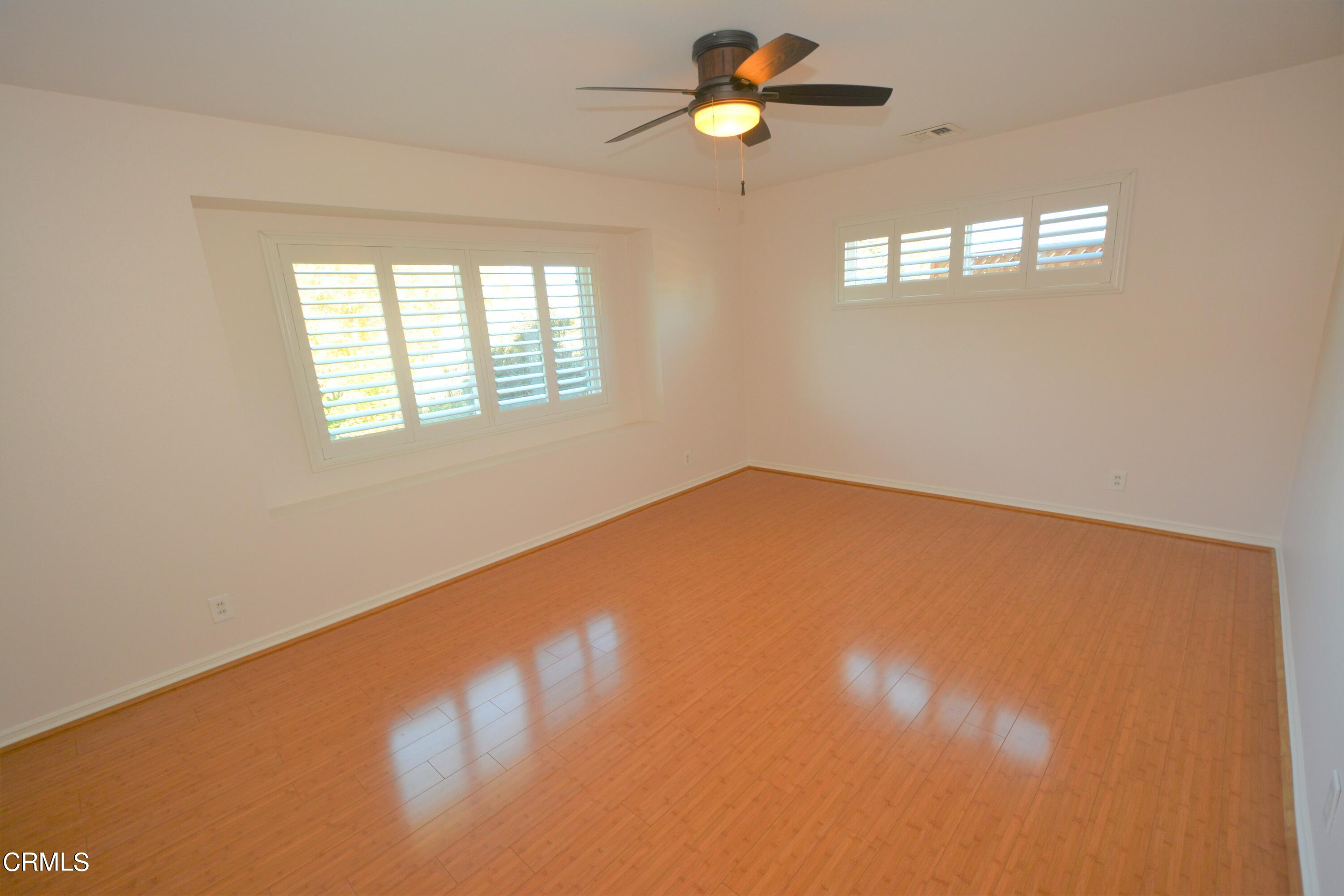 3252 Radcliffe Road Thousand Oaks, CA 91360 - Photo 20 of 31 an empty room with windows and ceiling fan view