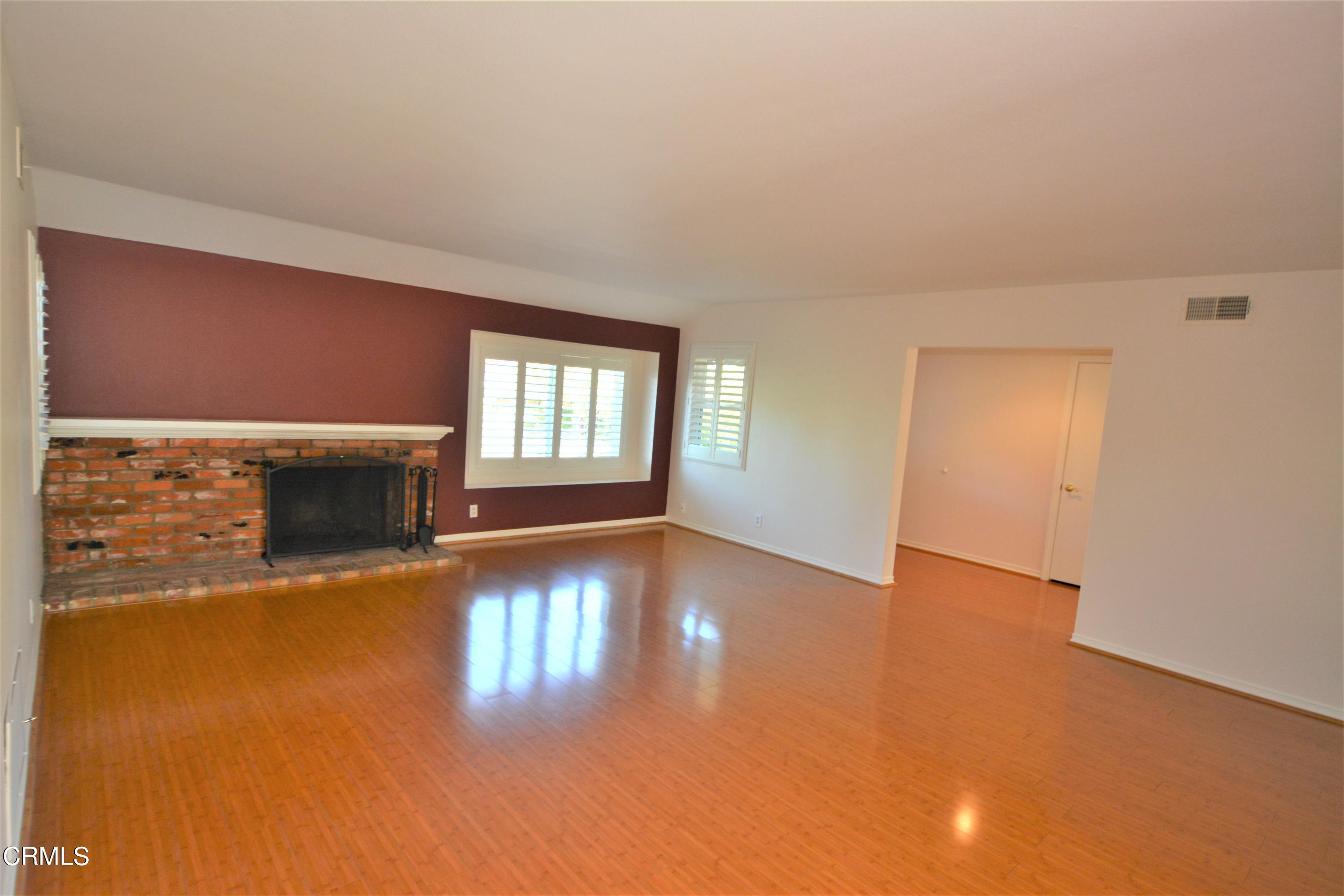 3252 Radcliffe Road Thousand Oaks, CA 91360 - Photo 5 of 31 a view of a livingroom with wooden floor and a fireplace