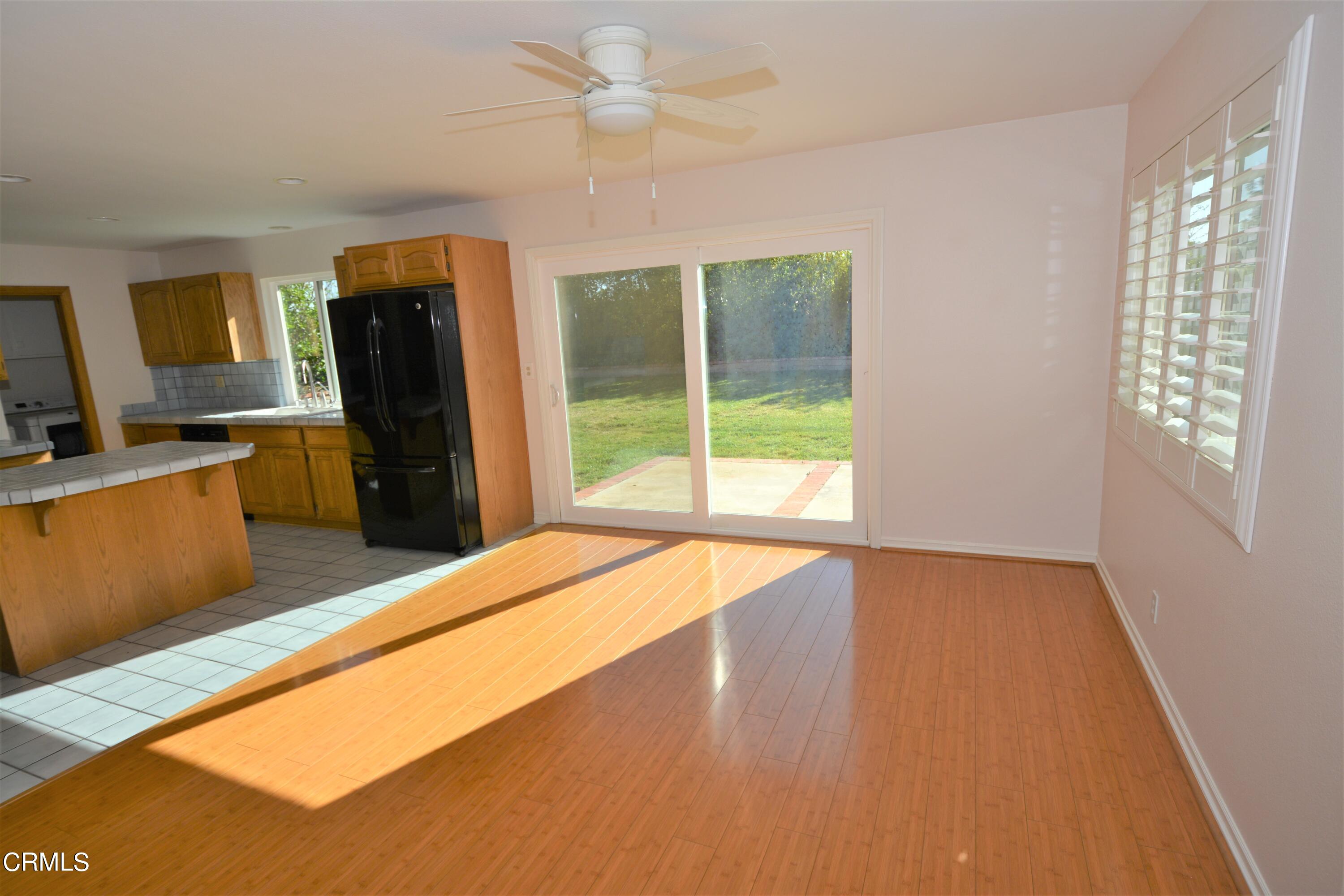 3252 Radcliffe Road Thousand Oaks, CA 91360 - Photo 8 of 31 a open kitchen with stainless steel appliances granite countertop a refrigerator a stove top oven a chimney next to a window