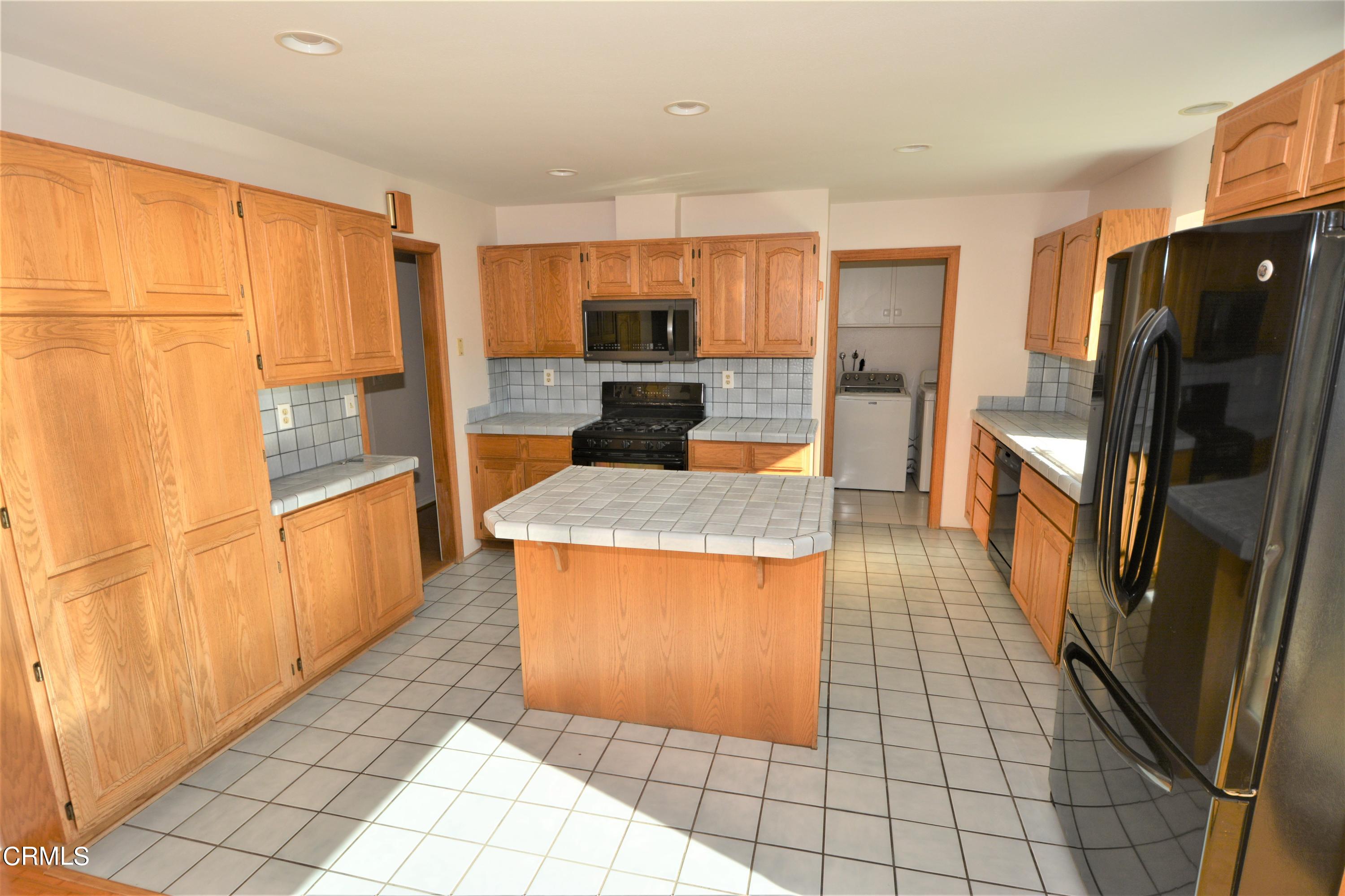 3252 Radcliffe Road Thousand Oaks, CA 91360 - Photo 9 of 31 a large kitchen with granite countertop a large counter top space and stainless steel appliances