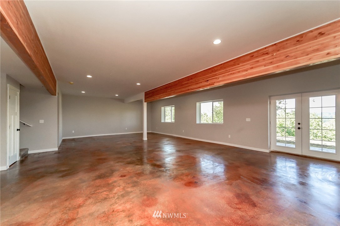 17611 Elhi Rim Road East Bonney Lake, WA 98391 - Photo 22 of 35 an empty room with wooden floor and windows