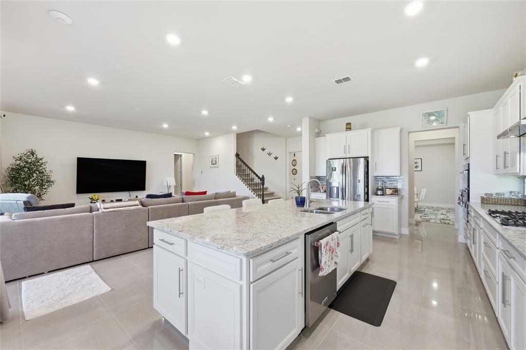 7537 Wandering Way Orlando, FL 32836 - Photo 13 of 71 a large kitchen with a large counter top appliances and living room