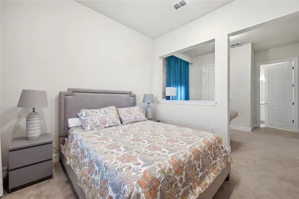 a living room with furniture and a refrigerator