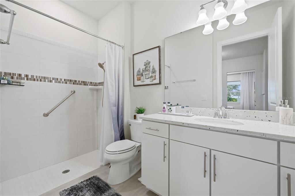 7537 Wandering Way Orlando, FL 32836 - Photo 22 of 71 a bathroom with a sink a toilet and a mirror