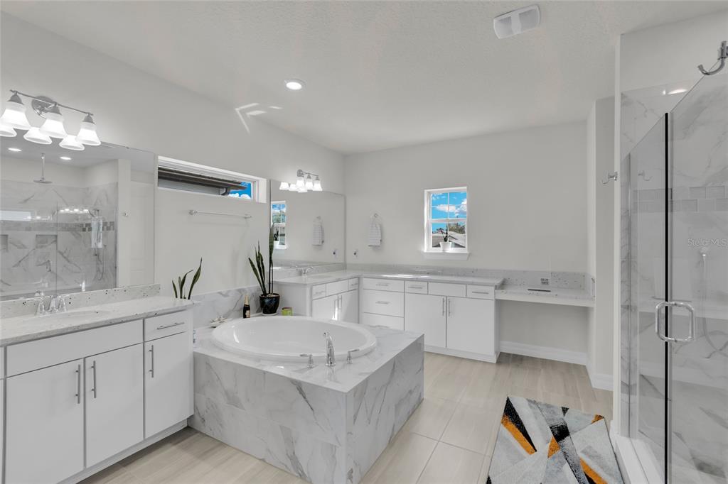 7537 Wandering Way Orlando, FL 32836 - Photo 30 of 71 a bathroom with a tub sink and mirror