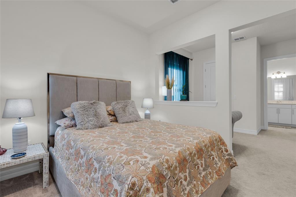 7537 Wandering Way Orlando, FL 32836 - Photo 43 of 71 a large bedroom with a bed and a lamp on table