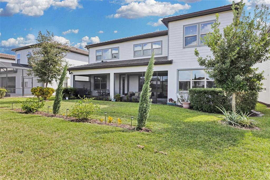 7537 Wandering Way Orlando, FL 32836 - Photo 52 of 71 a view of a house with a yard and plants