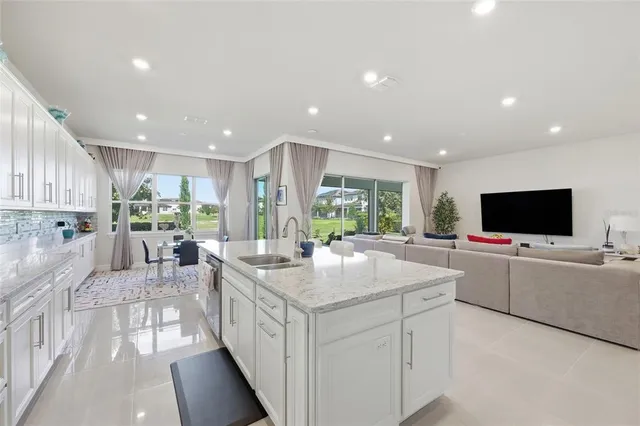 a large kitchen with a large counter top appliances and living room