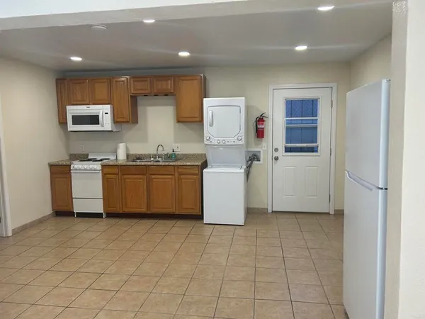 a kitchen with a sink a stove cabinets and counter space
