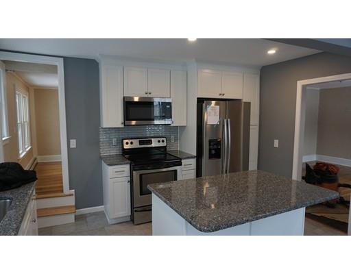 39 Neptune Avenue West Springfield, MA 01089 - Photo 2 of 28 a kitchen with a refrigerator a microwave a sink and cabinets