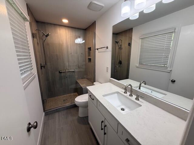 904 Brookwood Drive Raleigh, NC 27607 - Photo 10 of 12 a bathroom with a sink a toilet a mirror and shower