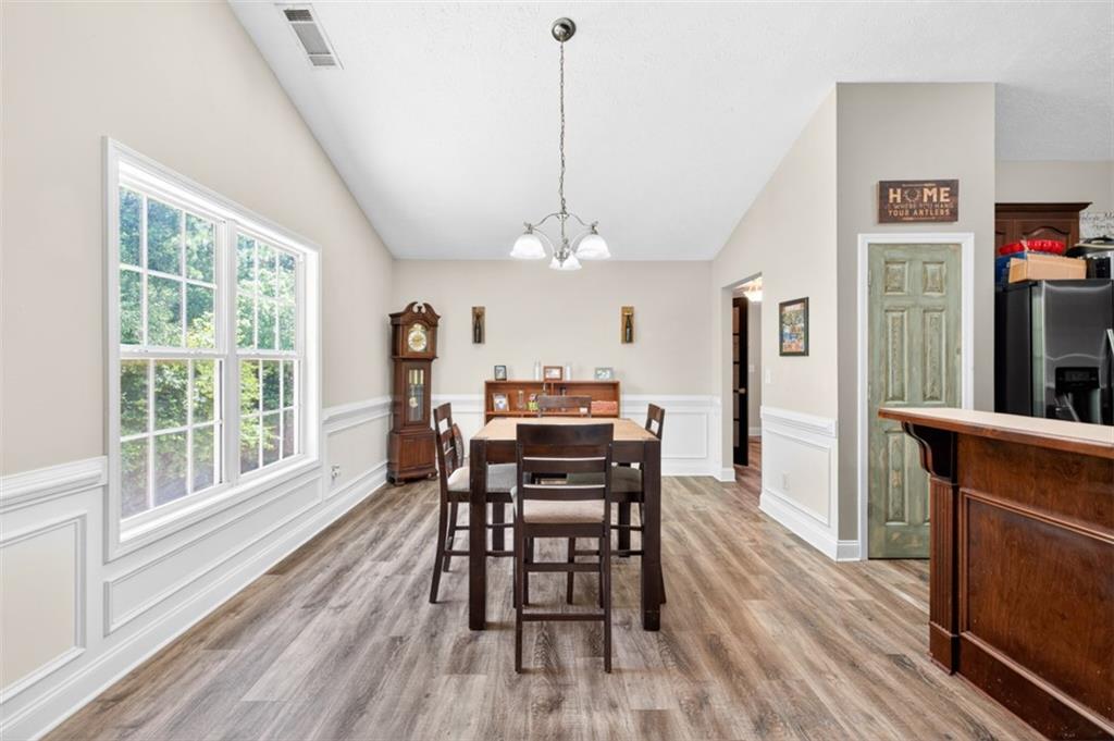 89 Katie Spring Lane Jefferson, GA 30549 - Photo 21 of 63 a view of a dining room with furniture window and wooden floor