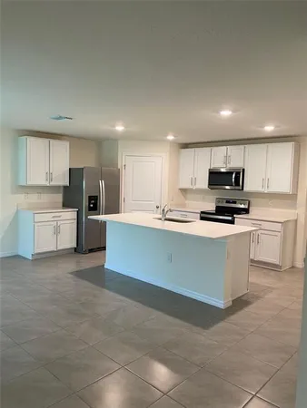 a large kitchen with cabinets and stainless steel appliances