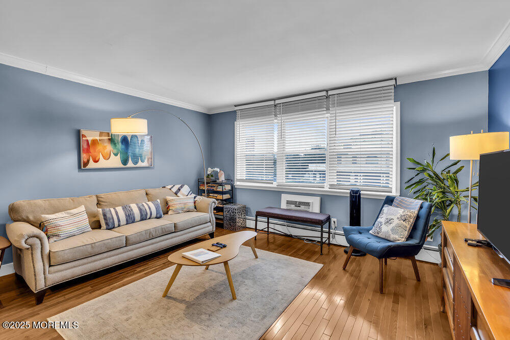 317 8th Avenue, Unit 303 Asbury Park, NJ 07712 - Photo 1 of 15 a living room with furniture and a large window
