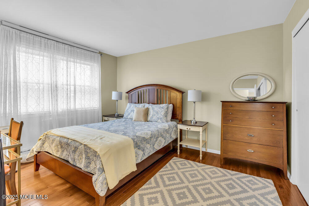 317 8th Avenue, Unit 303 Asbury Park, NJ 07712 - Photo 11 of 15 a bedroom with a bed and a window