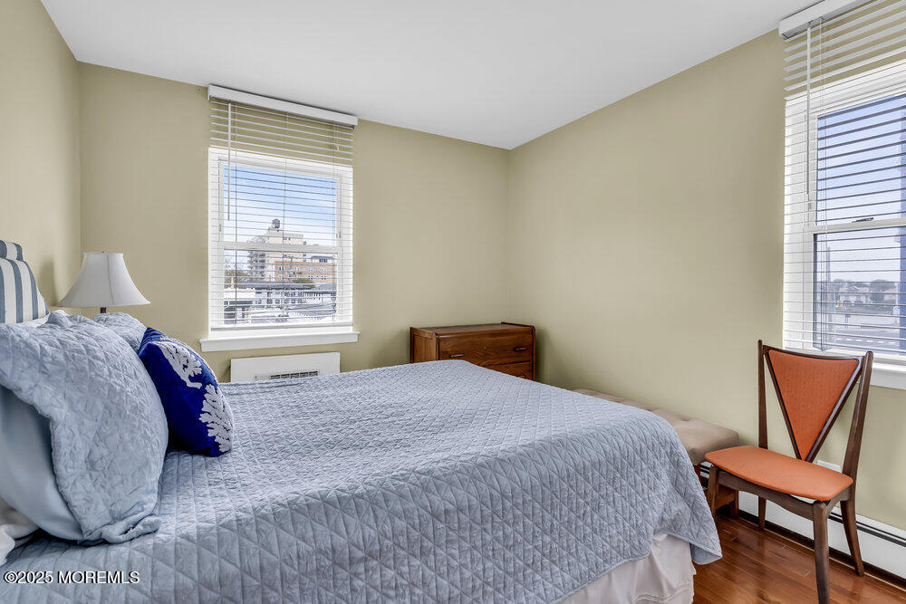 317 8th Avenue, Unit 303 Asbury Park, NJ 07712 - Photo 13 of 15 a bedroom with a bed and a chair