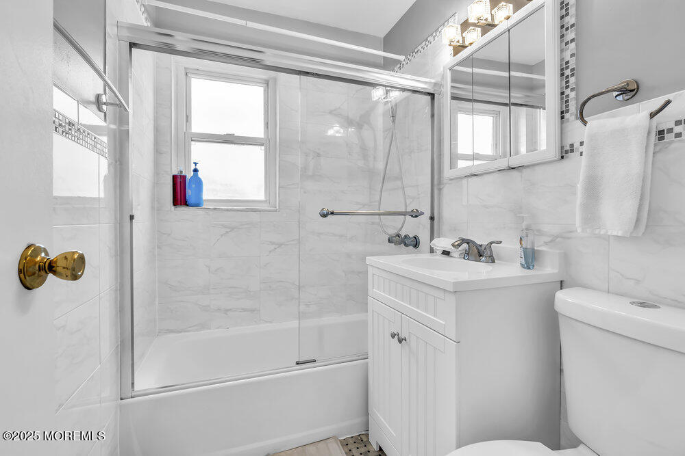 317 8th Avenue, Unit 303 Asbury Park, NJ 07712 - Photo 14 of 15 a bathroom with a sink toilet and shower