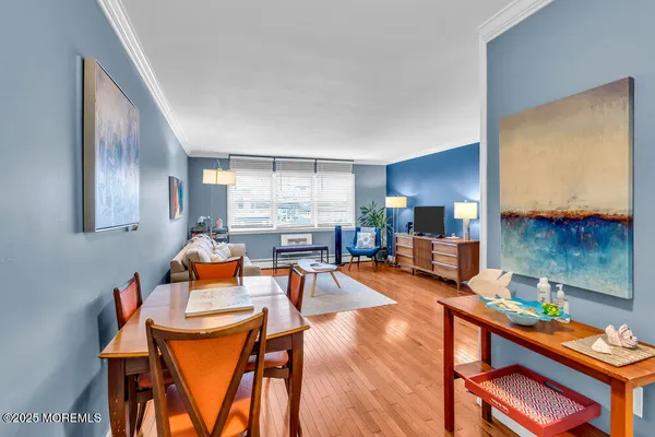 a dining room with furniture and wooden floor